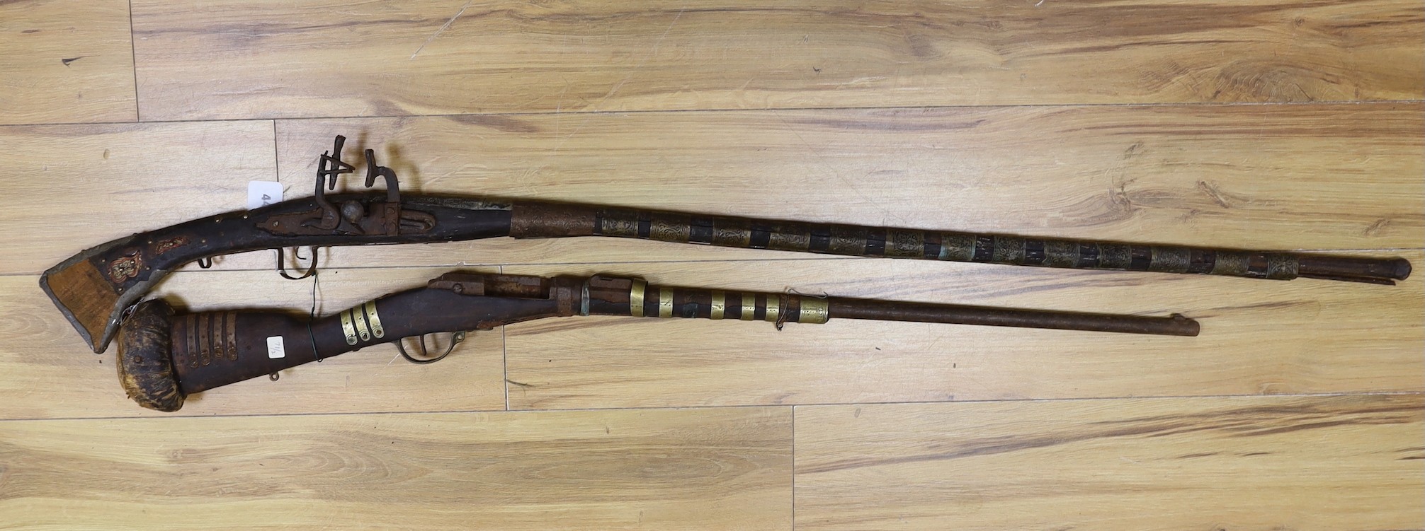 Two 18th century continental long arm rifles, longest 143 cms.